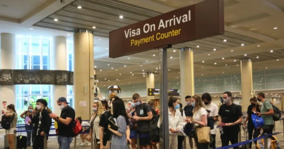 Bali airport visa on arrival counter area with travelers